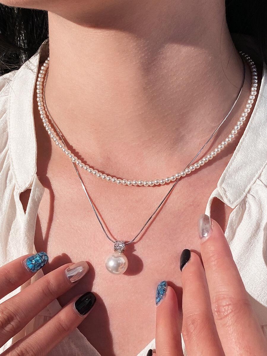 Necklace is round white necklace