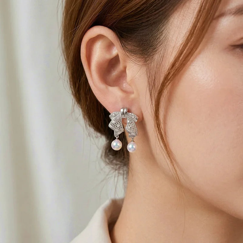 Hollow out large bow, exquisite mother shell pearl earrings, women's versatile earrings, fashionable and simple temperament